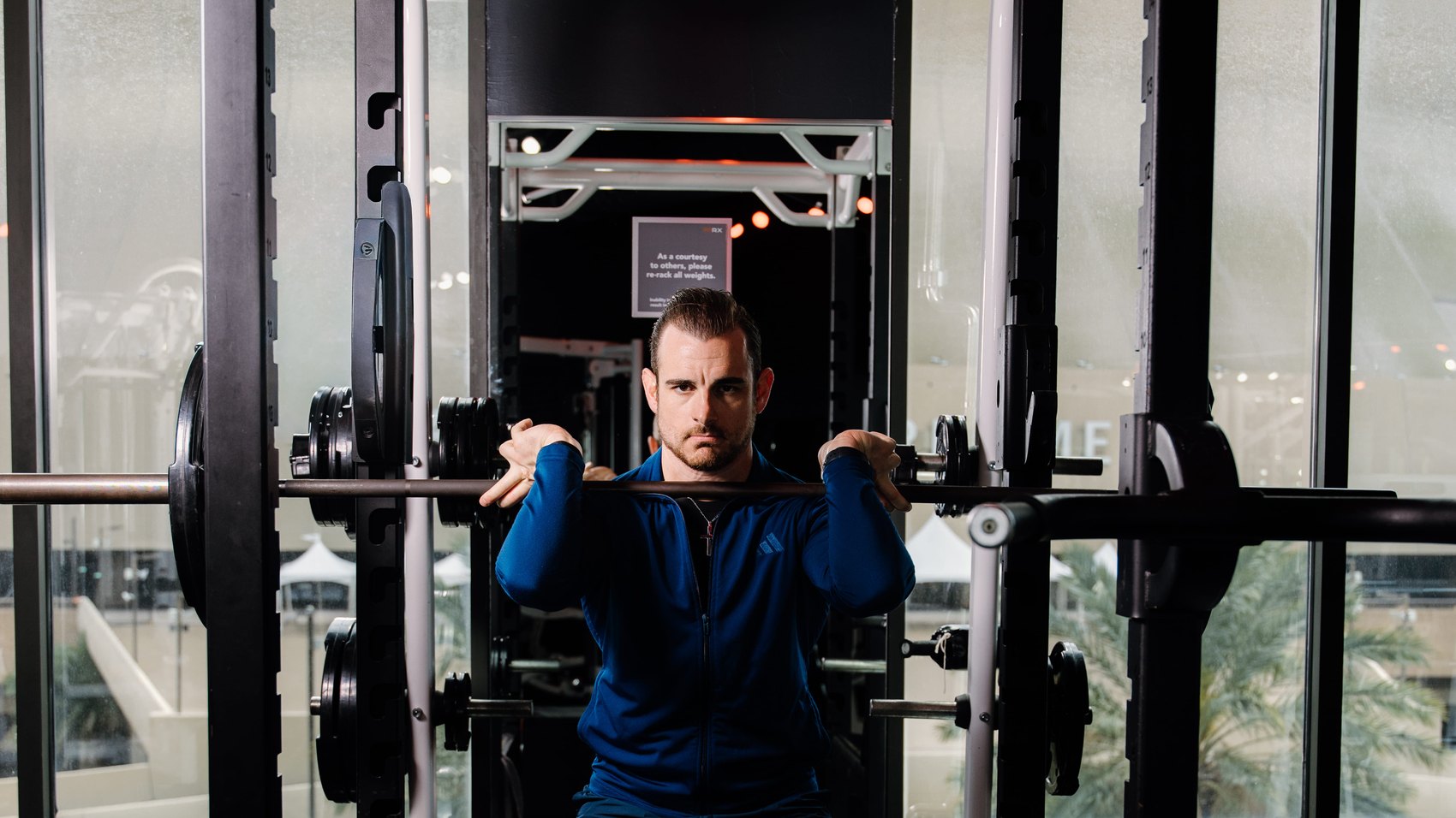 Jonathan Forstall under the bar in the squat rack